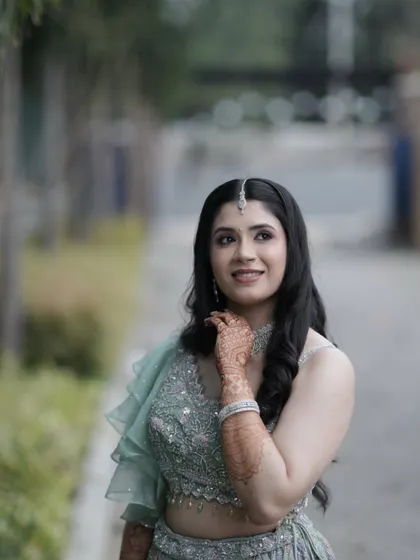 Grace in every detail. This bride looks ethereal in her pastel green lehenga for her Sangeet. The makeup is soft and romantic, with a focus on her glowing skin and bright smile.