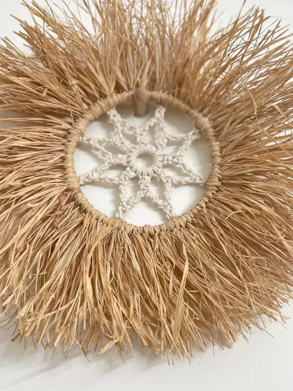 A close-up of the intricate macrame mandala at the center of my raffia wall hanging. I love combining different natural materials to create unique textures.