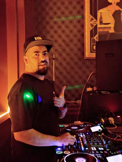 Giving a thumbs up from the DJ booth at 10SpeakEasy. The speakeasy vibe is always cool.
