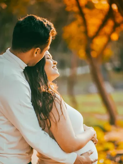 There's nothing like the magic of a sunset. This golden hour maternity photo captures the romance and warmth of this special time, set against a beautiful outdoor backdrop.