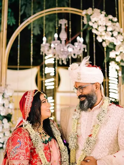 An intimate look between the bride and groom on their wedding stage. Even in a public setting, they find a moment that is just for them, a testament to their strong connection.