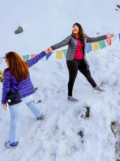 Two members of our group enjoying the snowy landscape at Khardungla Pass. Our trips are as much about friendship and fun as they are about fitness.