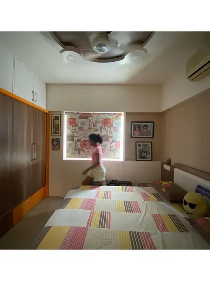 We designed floor-to-ceiling wardrobes to maximize storage in the children's rooms, using a combination of wood and white laminate to keep the space feeling light.