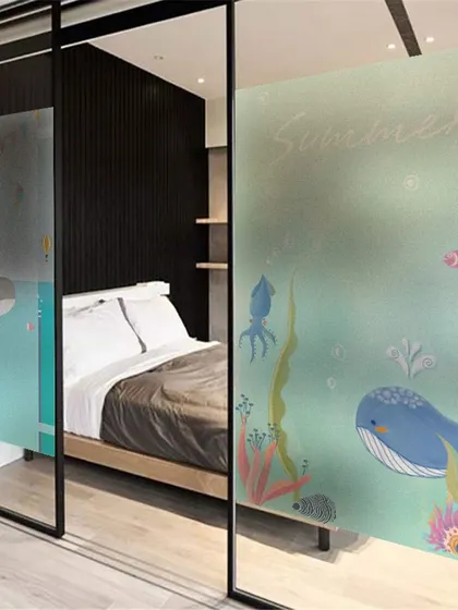 A charming underwater-themed frosted film for a child's bedroom or playroom. The colorful whales and sea life add a fun, imaginative touch while providing privacy.