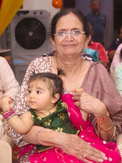 A precious moment between a grandmother and her grandchild during a family function.