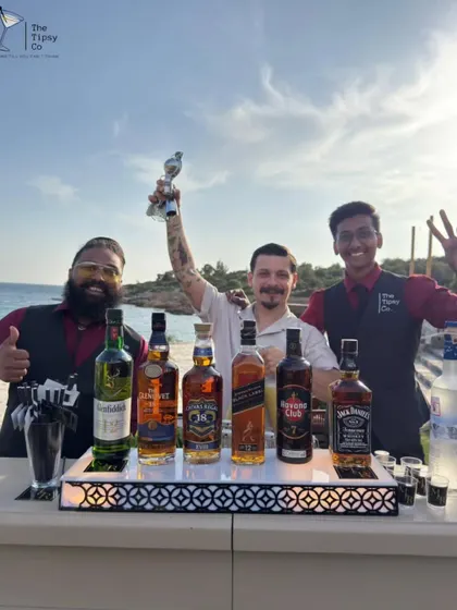 Our team celebrating a successful beachside event. We bring top-shelf spirits and top-tier service, no matter the location.