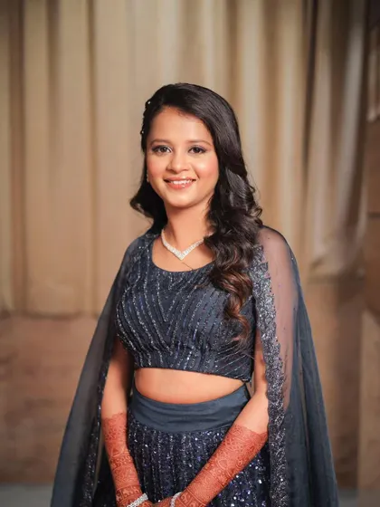 A full-length view of this sparkling navy blue lehenga. The makeup is kept clean and radiant to balance the intricate details of the outfit.
