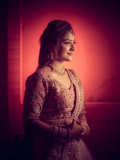 A beautifully lit portrait of the bride-to-be, with a soft red glow creating a romantic and modern feel.