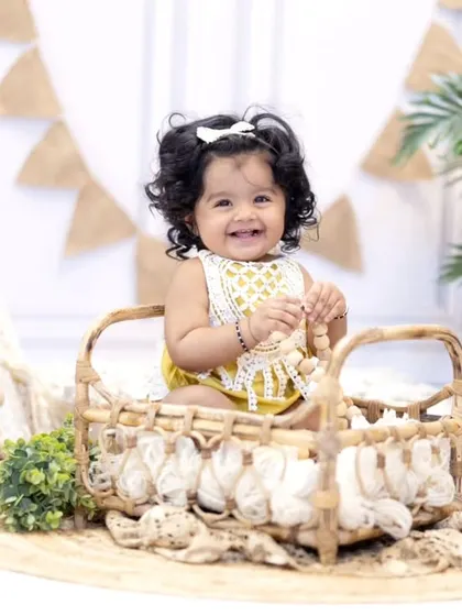 Sitting pretty in a wicker basket, this little girl enjoys her first birthday celebration. I use a variety of props to keep the session engaging and fun.