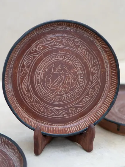 Inspired by antique bronze plates, these intricately carved ceramic plates were crafted by a student in our Foundation course. The detailed sgraffito work and rich glaze give them a timeless, heirloom quality.