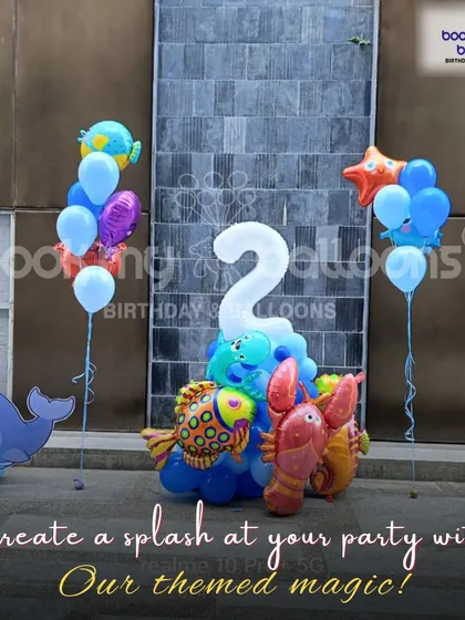 This under the sea themed second birthday setup shows how we can create a splash with our themed magic. The decor includes fish and lobster foil balloons and a cute whale cutout.