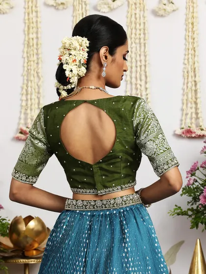The back of the olive green blouse features a modern keyhole design, adding a contemporary touch to this traditional ensemble.