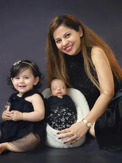 A mother's love with her two little ones. The older sister's happy smile next to her new baby brother makes this such a heartwarming sibling and newborn portrait.
