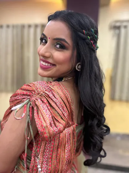 This over-the-shoulder shot highlights both the colorful hairstyle and the radiant smile of the bride.