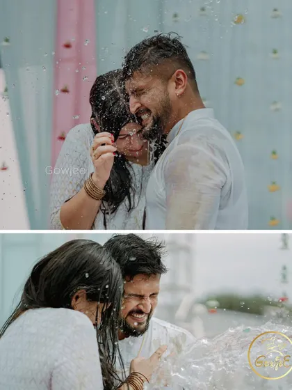 The couple getting drenched together, a fun and memorable part of their Haldi celebration.