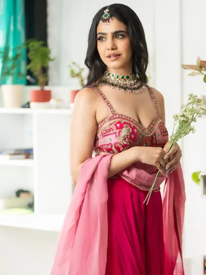 A closer look at the embroidered blouse and the delicate fabric of the dupatta. I focus on poses that highlight the outfit's best features.
