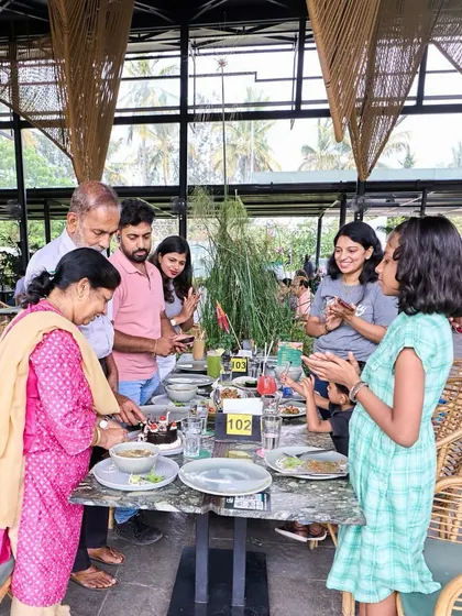A family celebrating a birthday, with children clapping and enjoying the moment.