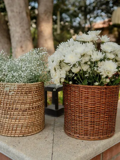 Wicker baskets with white flowers, a simple and rustic decor element.