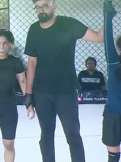 A referee raises our fighter's hand in victory. We train our athletes to be ready for these moments, and we stand united behind them.