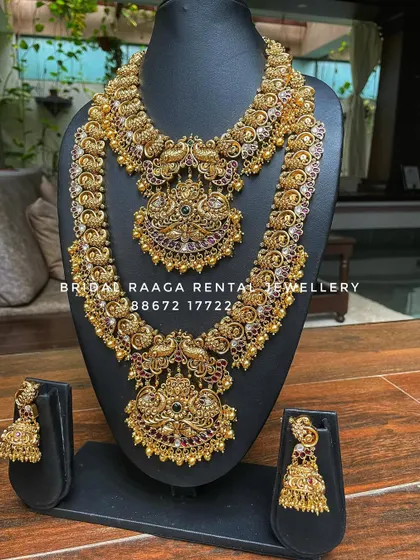 A beautiful peacock-themed bridal set in an antique finish. Both the choker and the long haram feature intricate peacock motifs studded with Kemp stones.