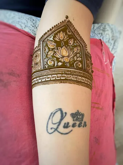 A beautiful lotus arm band design placed just above a client's tattoo. I can customize the placement and style to suit your preference.