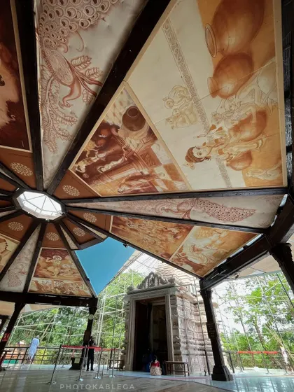 An upward view of the artistically painted ceiling inside a temple structure at the ecovillage.