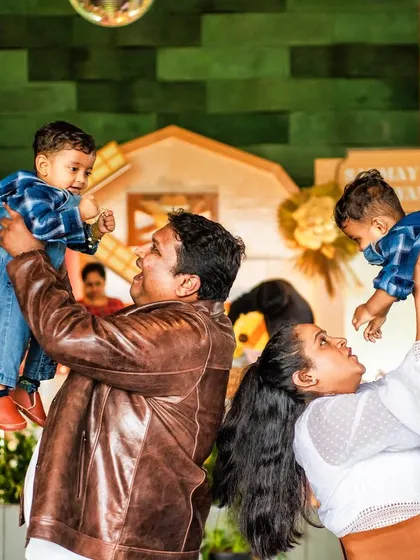 Double the joy! The parents celebrate with their twin boys at the farm-themed party. Capturing these happy family moments is the best part of my job.
