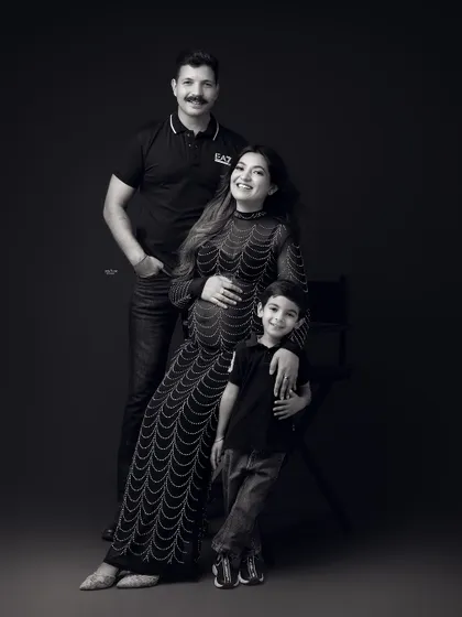 A stylish black and white family portrait. This family's got swag. The coordinated black outfits look so chic and modern.