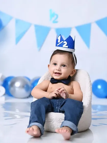 The king of his half-birthday castle! A cute shot of a 6-month-old wearing a celebratory crown.