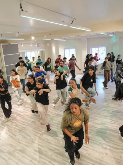 The whole floor moving as one during a high-energy routine at our Launch Weekend. This is the community vibe we strive to create in every workshop.