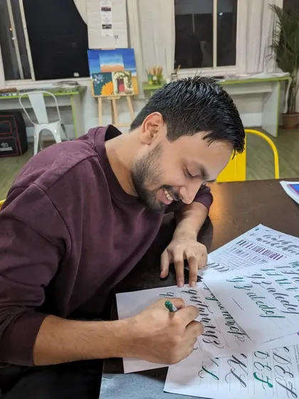 A participant practicing his calligraphy during our DIY event.