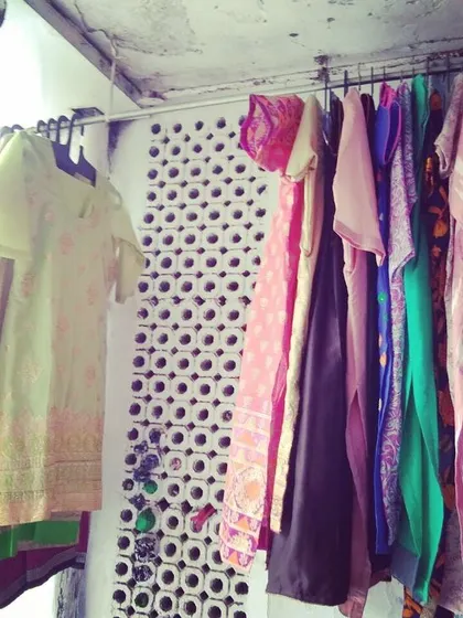 Finished garments hanging on the rack, ready for clients. Every piece is stitched with care, focusing on neat seams and a professional finish.