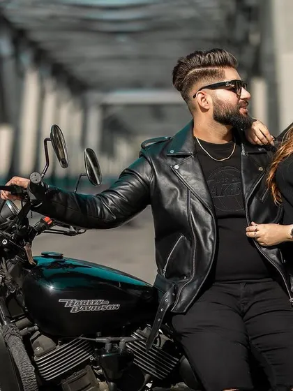 A cool and intimate portrait of the couple posing with their Harley Davidson on a bridge. This shot highlights their connection and shared style.