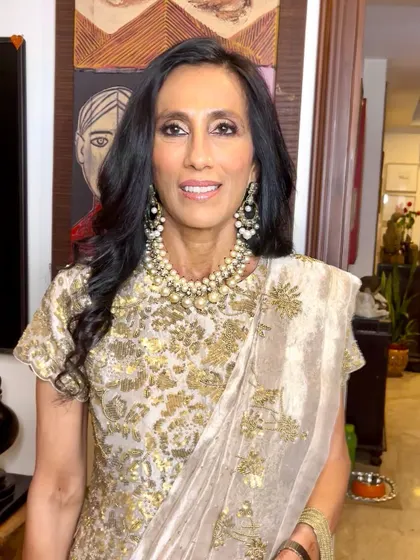 This mother of the groom is the picture of sophistication in a gold and pearl ensemble. The makeup is kept warm and glowing.