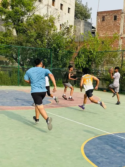 Players running a fast break during a senior team scrimmage. We emphasize speed and quick transitions.