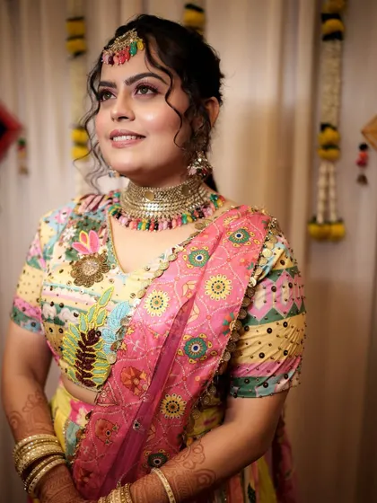 Another angle of the vibrant Haldi look. The makeup complements her multi-colored outfit and jewelry perfectly.