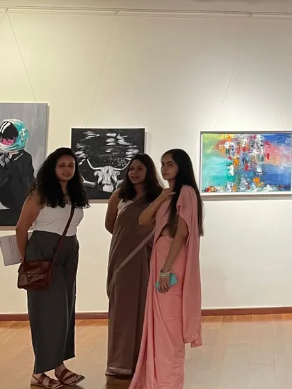 A photo from my 'Follow the sun' exhibition at The Stainless Gallery. Here I am discussing my work with visitors, sharing the stories behind my surreal and abstract paintings.