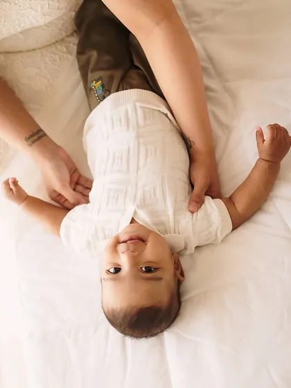 A playful moment with mom. This upside-down view shows the fun and laughter we incorporate into our milestone sessions.