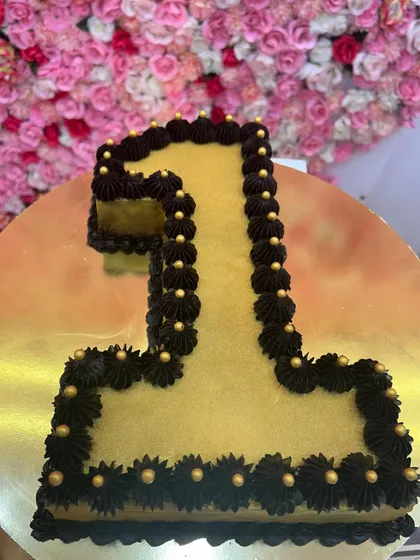 A number-shaped cake, perfect for celebrating a first birthday. This "1" shaped cake is decorated with rich chocolate frosting.
