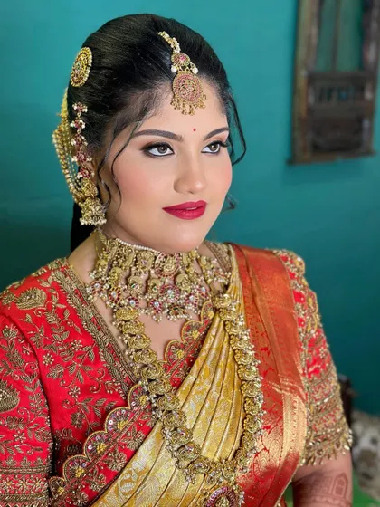 A close up portrait of a bride with a classic red lip and winged eyeliner. This timeless look is perfect for a traditional wedding ceremony.