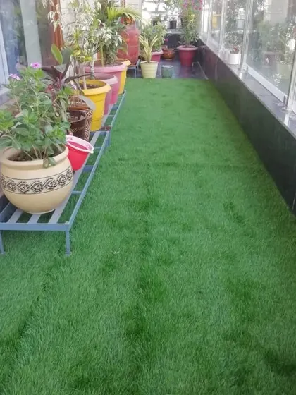 This long, narrow balcony is now a beautiful green walkway. The 35mm grass is soft and durable, perfect for daily use and placing plant stands on.