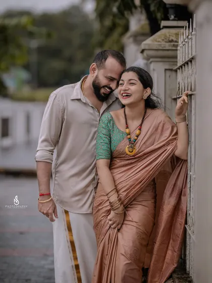 A cozy and happy embrace by a gate. This shot is full of warmth and genuine affection.