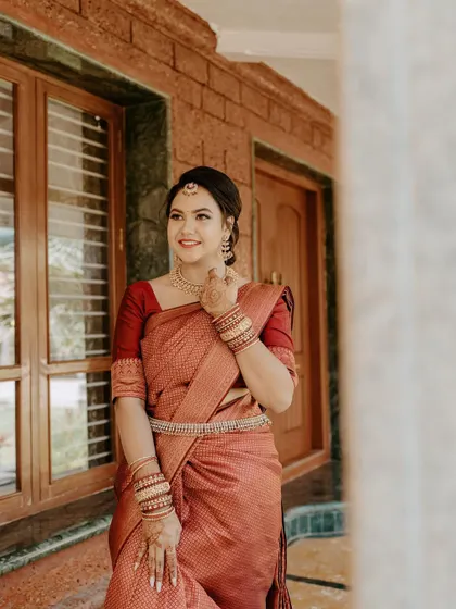 A happy, candid moment. The bride's natural glow is enhanced with soft makeup, letting her smile be the centerpiece of this beautiful engagement look.