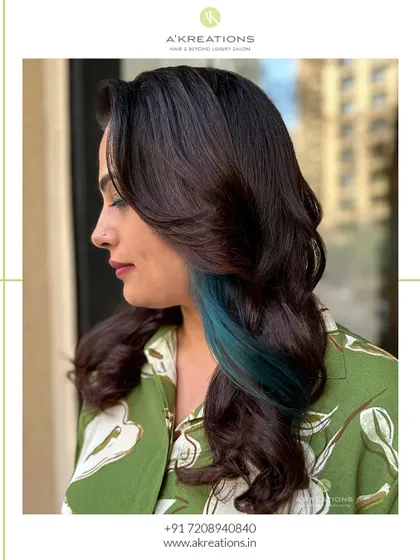 A profile view of the peacock green peekaboo highlights, showing how they add a surprising and stylish element to the haircut.