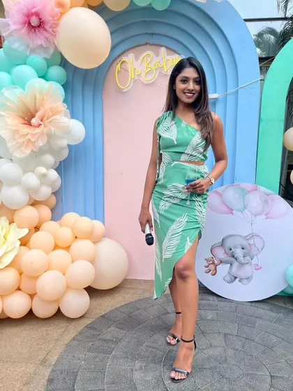 A smiling photo with the mic in hand at the baby shower.