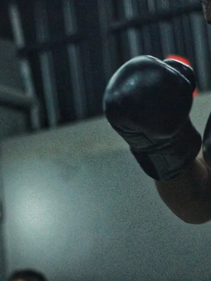 Two fighters in a defensive stance, gloves up, eyes locked. This is the foundation of everything we do in the ring.