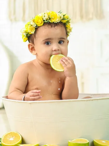 When life gives you lemons, you taste them. This funny and adorable shot captures a baby's reaction to a sour lemon slice during a milk bath.
