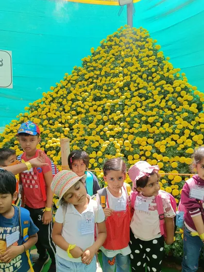 Children stand in awe in front of a giant pyramid of marigolds at the Lalbagh Flower Show. The scale and beauty of the displays were truly inspiring.