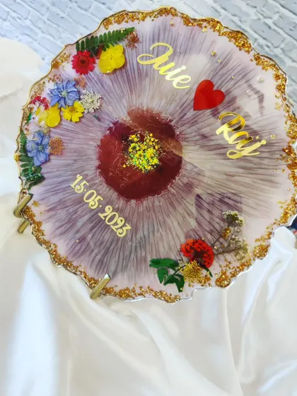Another angle of the purple floral plaque, showing the gold-lined edge and the sparkle from the glitter at the center.