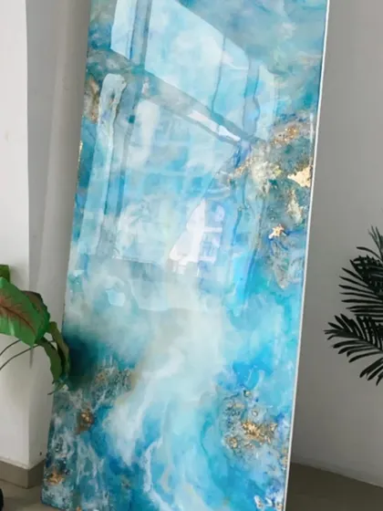 An abstract ocean art panel with flowing blues, whites, and hints of gold foil, creating a sense of movement and depth like waves crashing on the shore.